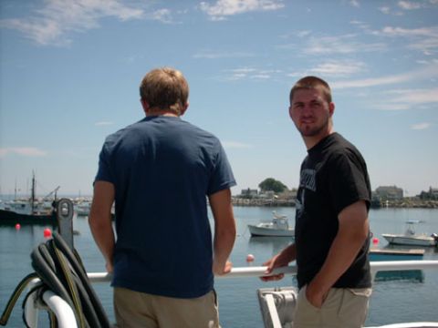 1986 Ford Bronco - Two men observe a busy harbor filled with various boats on a clear day.