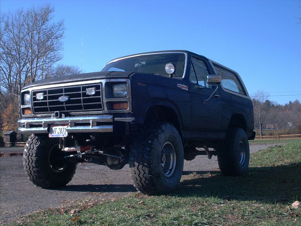 Lifted Ford Bronco with aftermarket grille and bumper. License plate reads JIT 2871