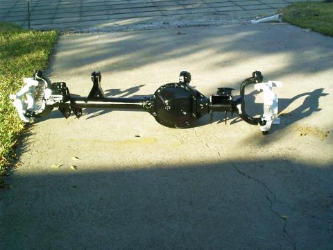 1986 Ford Bronco - A rear axle assembly, likely from a truck or SUV, is shown outdoors on a paved surface.