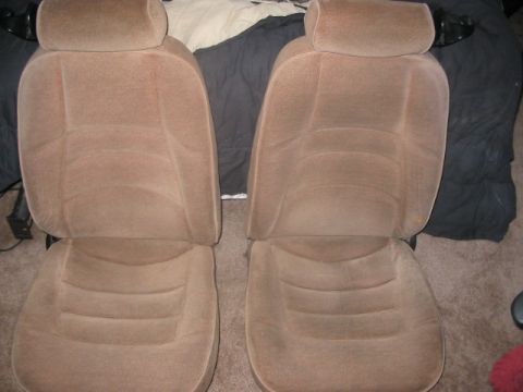 1991 Ford Bronco - Pair of tan cloth bucket seats, likely from an older SUV or truck, are shown from the front.