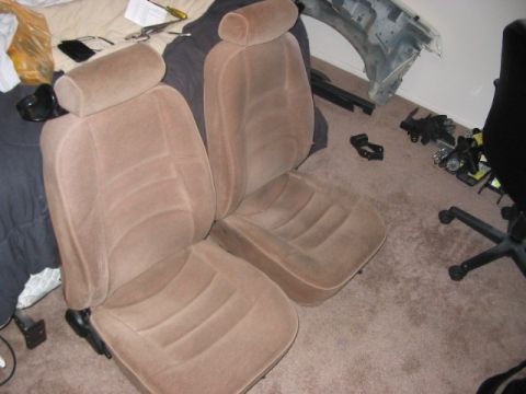 1991 Ford Bronco - Car seats are shown indoors with various tools and car parts in the background.