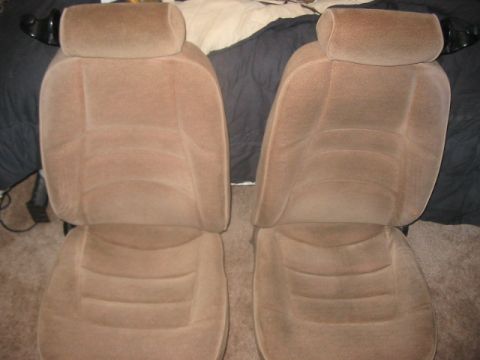 1991 Ford Bronco - A pair of tan fabric car seats are shown, likely removed from a vehicle.