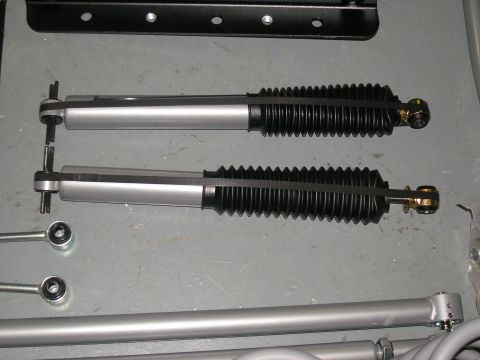 2001 Jeep Wrangler - Two shock absorbers are shown, along with other suspension components, against a gray background.