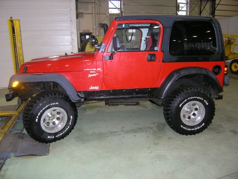 2001 Jeep Wrangler - Side view of a red 2001 Jeep TJ Wrangler Sport 4.0L with a black hardtop.