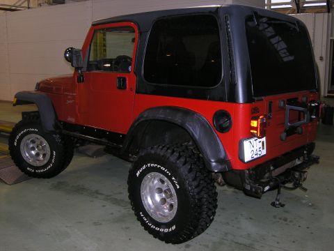 2001 Jeep Wrangler - This Jeep Wrangler is shown from the rear-three-quarter view, highlighting its off-road modifications and hardtop.