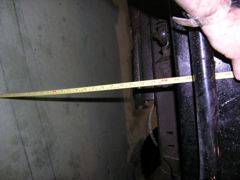 2001 Jeep Wrangler - A tape measure is used to measure a section of the vehicle's frame.