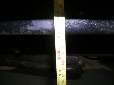 2001 Jeep Wrangler - A close-up view of a vehicle's frame with a measuring tape indicating dimensions.
