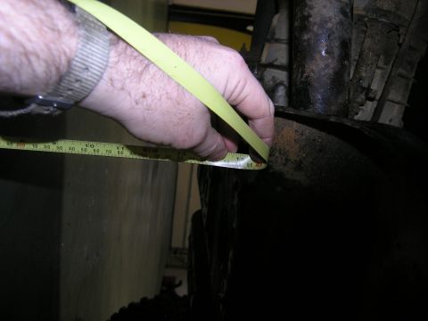 2001 Jeep Wrangler - Measuring a suspension component with a yellow tape measure.