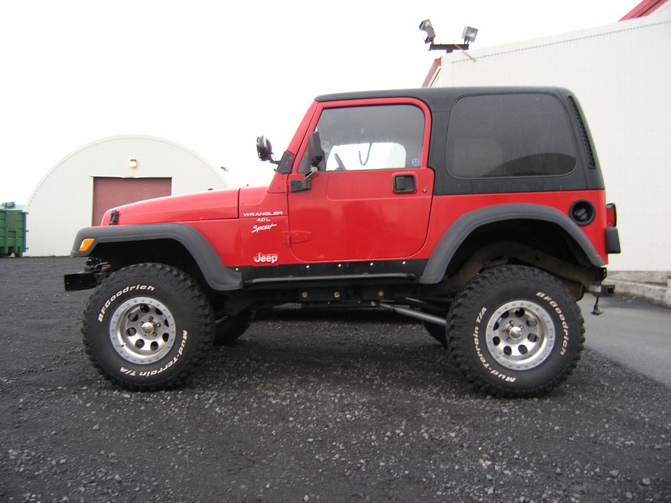Red 2001 Jeep TJ Wrangler Sport side view with black hardtop and BFGoodrich tires