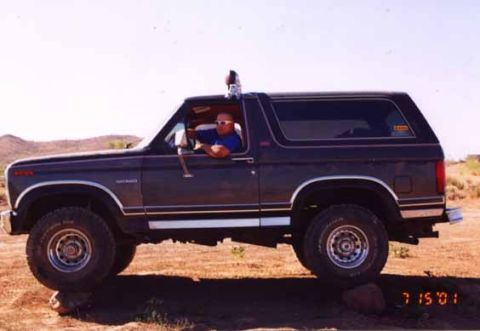 1993 Ford Bronco - A driver is seen behind the wheel of a 1993 Ford Bronco parked outdoors.
