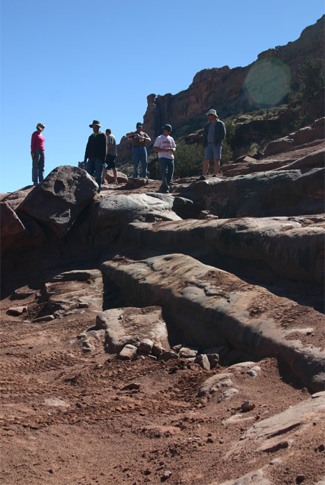 1993 Ford Bronco - A group of people are gathered on a , rocky terrain with a mountain in the background.