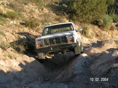 1983 Ford Bronco - This 1980s Ford Bronco tackles a challenging off-road trail.