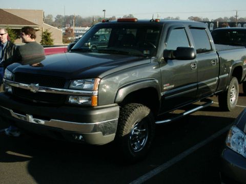 2002 Ford F-250 - This dark gray pickup truck, seen from a 3/4 front angle, is likely a 2003 Chevrolet Silverado 2500HD, not the 2002 Ford F-250 listed in th…