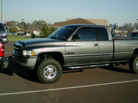 2002 Ford F-250 - Side view of a gray Dodge Ram pickup truck parked in a lot.