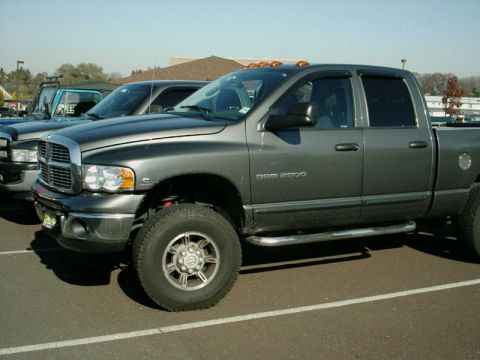2002 Ford F-250 - Gray Dodge Ram 2500 pickup truck parked in a lot, with another vehicle visible to the left.