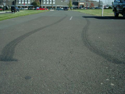 2002 Ford F-250 - Tire marks are visible on the asphalt, indicating recent vehicle activity.