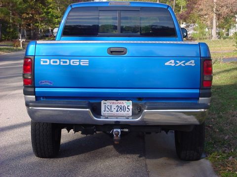1989 Ford Bronco - This blue Dodge pickup truck is shown from the rear, displaying its 4x4 badging and Virginia license plate.