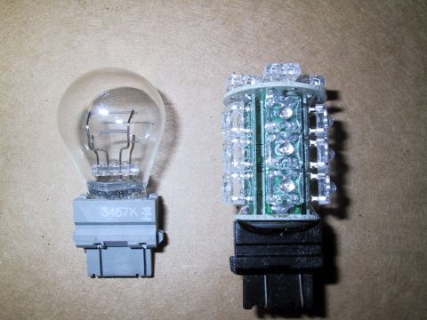 2003 Ford Crown Victoria - Comparison of an old incandescent bulb and a new LED bulb, showing the difference in technology.