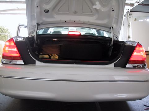 2003 Ford Crown Victoria - Rear view of a 2003 Ford Crown Victoria with the trunk open, revealing contents.