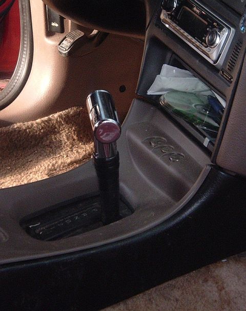 1994 Ford Thunderbird - Interior view of a car's center console, highlighting the gear shifter and radio.