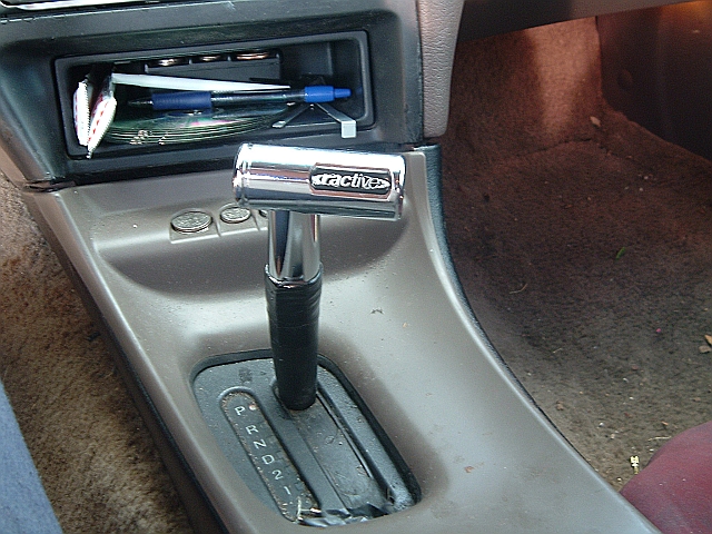 Interior shot of a car's automatic gear shifter with "Tractives" branding