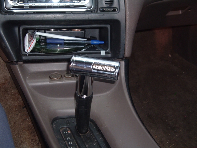 Chrome Tractive shifter handle in tan and black center console with automatic gate