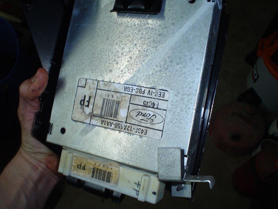 Ford electronic control unit with labels showing part numbers and 'EEC-IV FBC-EGR'