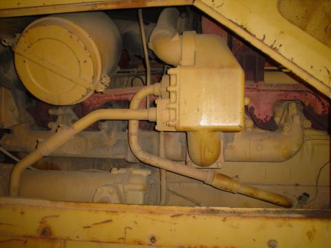 1966 International School Bus - Close-up view of engine components, including an air filter and fuel filter housing.