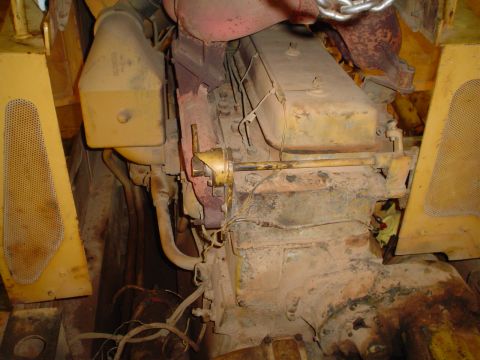 1966 International School Bus - Close-up view of a yellow engine block with visible red accents and exhaust components.
