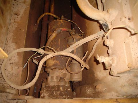 1966 International School Bus - Close-up of a starter motor and its associated wiring, showing significant dirt and grime.