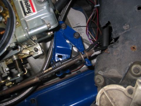 1985 Ford Crown Victoria LTD - Detail shot of engine components, including a carburetor and custom blue linkage, with visible wiring and cables.