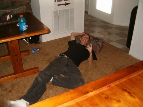 1991 Ford Bronco - Man relaxing on the floor indoors, with a table and a drink nearby.