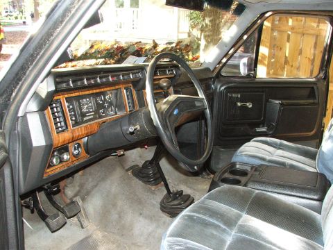 1996 Ford Bronco - Interior of an older truck, showing the dashboard, steering wheel, and front seats.