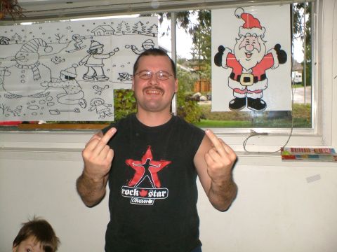 1989 Ford Bronco - A man stands in front of a window decorated with holiday drawings and gives the camera the middle finger.