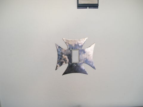 1993 Ford Bronco - Custom metal Iron Cross light switch cover plate mounted on a wall.