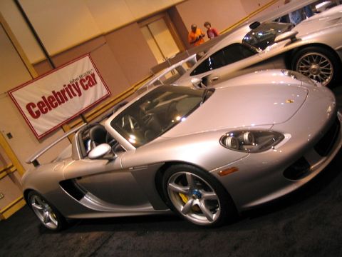 1997 Ford Probe - Silver Porsche Carrera GT on display at an indoor event, with a banner reading 'Celebrity Car'.