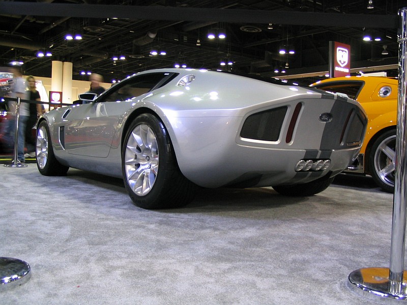 Silver concept car rear view with racing stripes and quad exhaust pipes