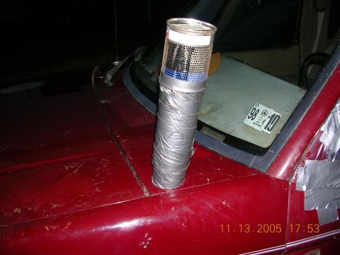 1989 Ford Bronco II - A homemade snorkel, constructed from cans and duct tape, is affixed to the hood of a red vehicle.