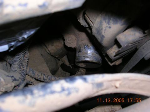 1989 Ford Bronco II - This image shows a close-up view of various engine components, including hoses and wiring, covered in dirt.