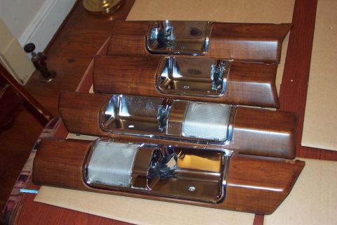 1985 Ford LTD Crown Victoria - Set of four woodgrain interior door panels, likely for a classic American sedan, chrome accents and pull handles.