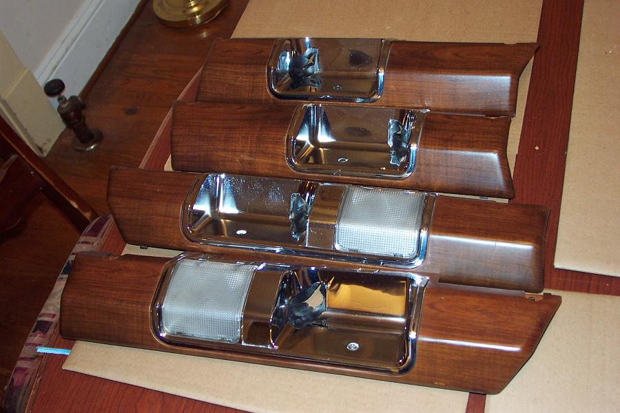 Four woodgrain interior door panels with chrome trim and pull handles