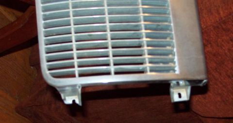 1985 Ford LTD Crown Victoria - This is a close-up view of a vehicle grille, showing its horizontal slat design and mounting points.