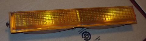 1985 Ford LTD Crown Victoria - An amber turn signal assembly is shown against a cardboard background.