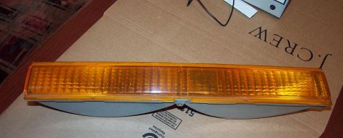1985 Ford LTD Crown Victoria - Amber marker light with ribbed lens, likely for a car part.
