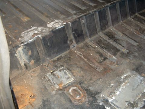 1978 Ford Bronco - Interior floor pan shows significant rust and repair work.