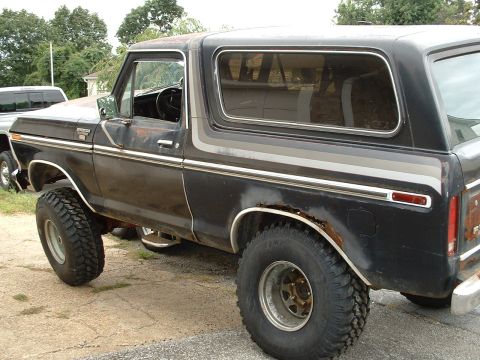 1978 Ford Bronco - This black 1978 Ford Bronco shows signs of wear and tear, including rust around the wheel wells.