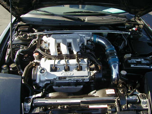 Engine bay with V6 engine and blue intake piping