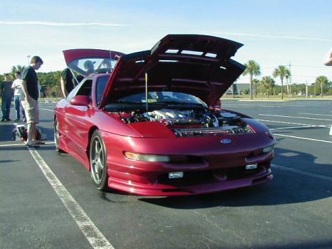 1994 Ford Probe - A red 1994 Ford Probe is displayed with its hood open, revealing the engine compartment.