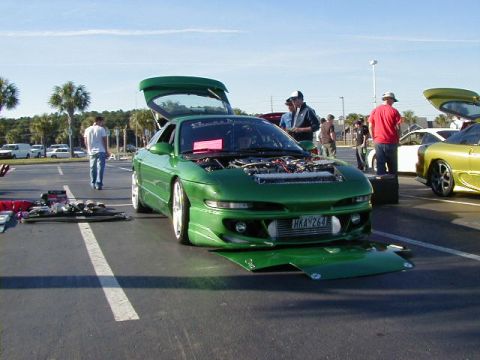 1994 Ford Probe - A modified green 1994 Ford Probe is displayed with its hood open at an outdoor event.