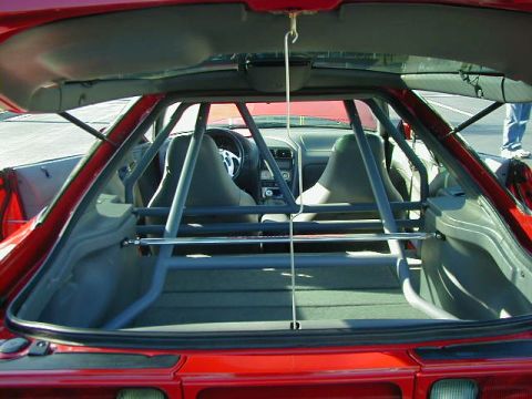 1994 Ford Probe - The interior of a 1994 Ford Probe features racing seats and a prominent roll cage, suggesting track use.